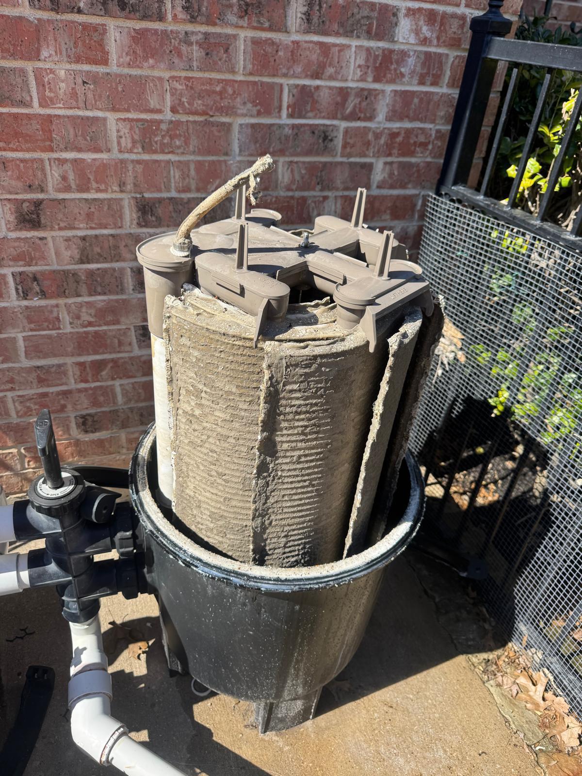DE filter grids caked with debris before cleaning