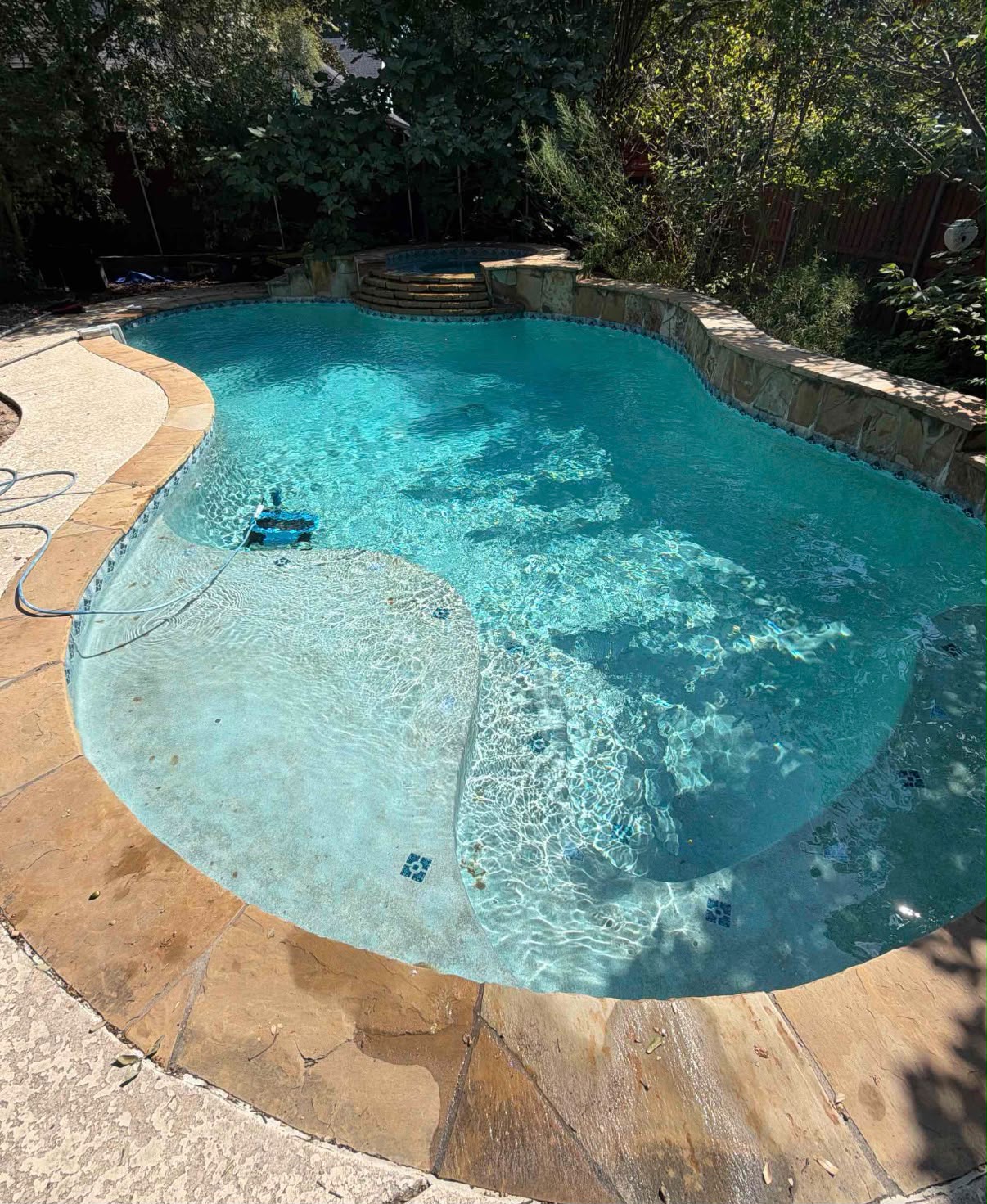 The same backyard pool with clear water after recovery